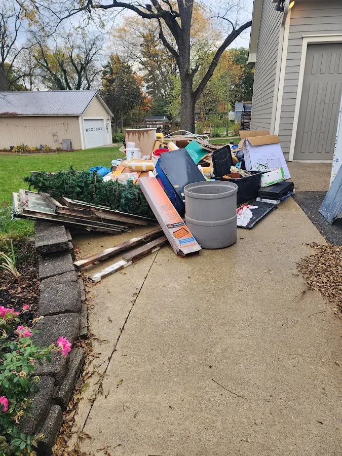 Dumpster being loaded with debris for Roofing Dumpster Rental in Dearborn Heights